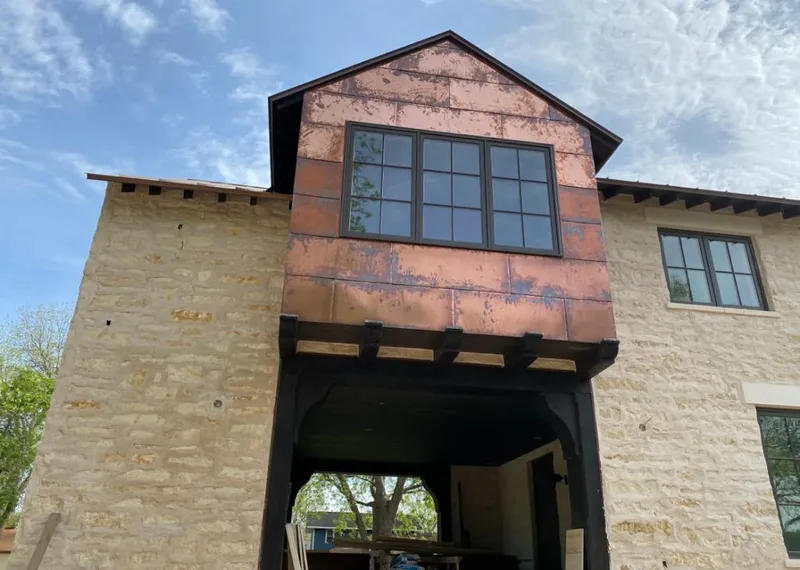 Copper metal panel facade on a stone building for Skylight Installation in South Sioux City